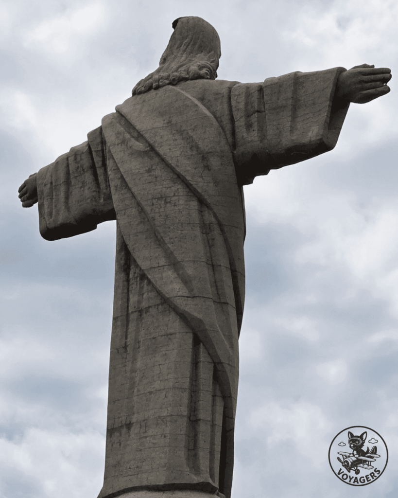 Statue du Cristo Rei de Garajau vue de dos sous un ciel nuageux