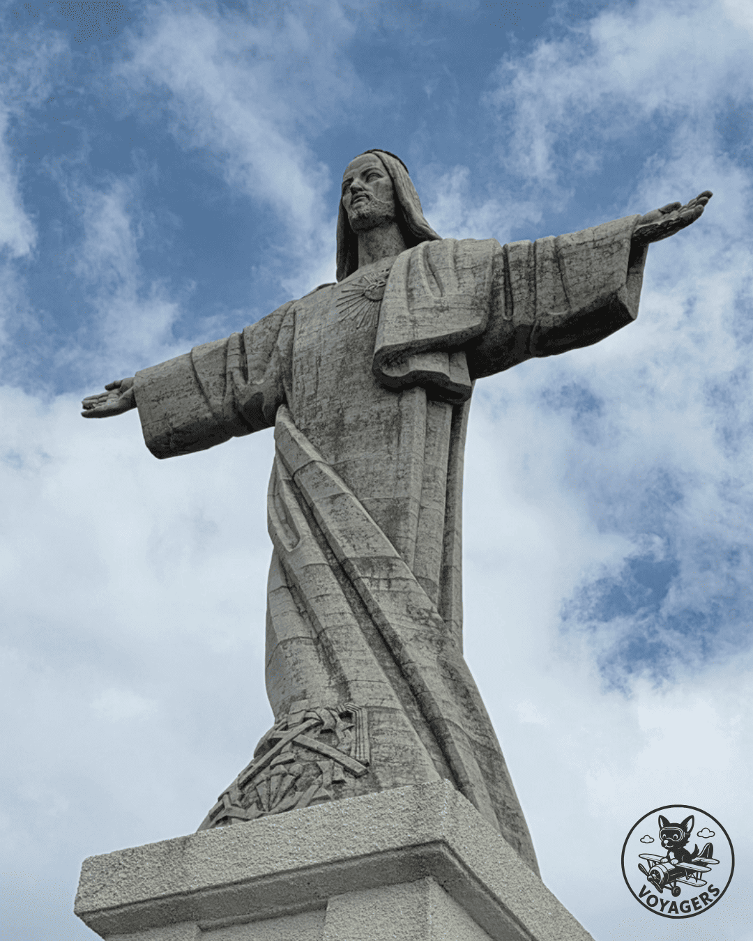 Statue du Cristo Rei de Garajau photographiée en contre-plongée sous le ciel